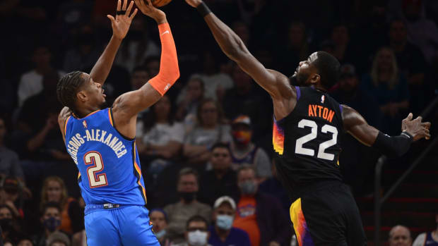 Dec 23, 2021; Phoenix, Arizona, USA; Oklahoma City Thunder guard Shai Gilgeous-Alexander (2) has his shot blocked by Phoenix Suns center Deandre Ayton (22) during the first half at Footprint Center. Mandatory Credit: Joe Camporeale-USA TODAY Sports